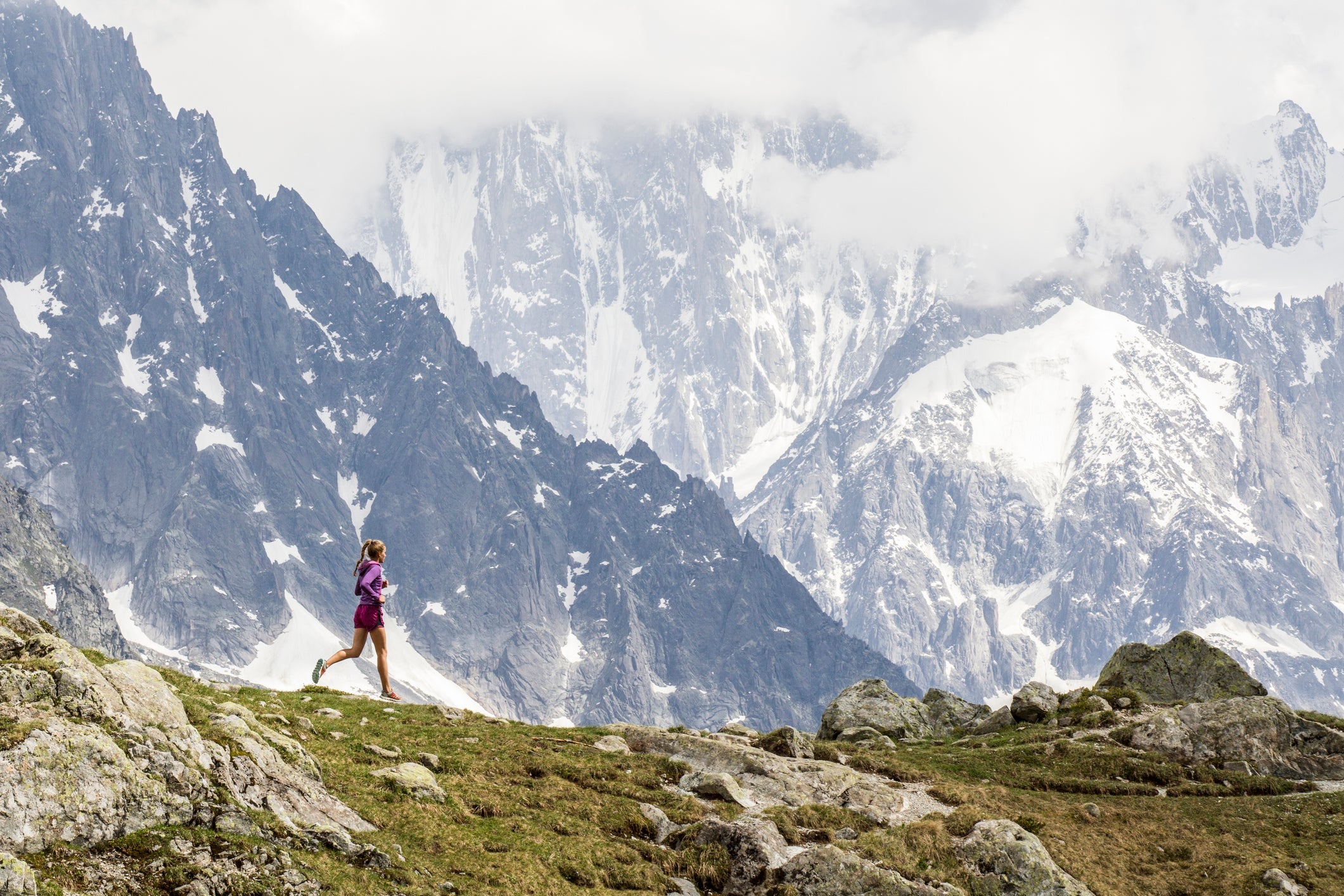 Girl trail running in Chamonix around the Chesery lake