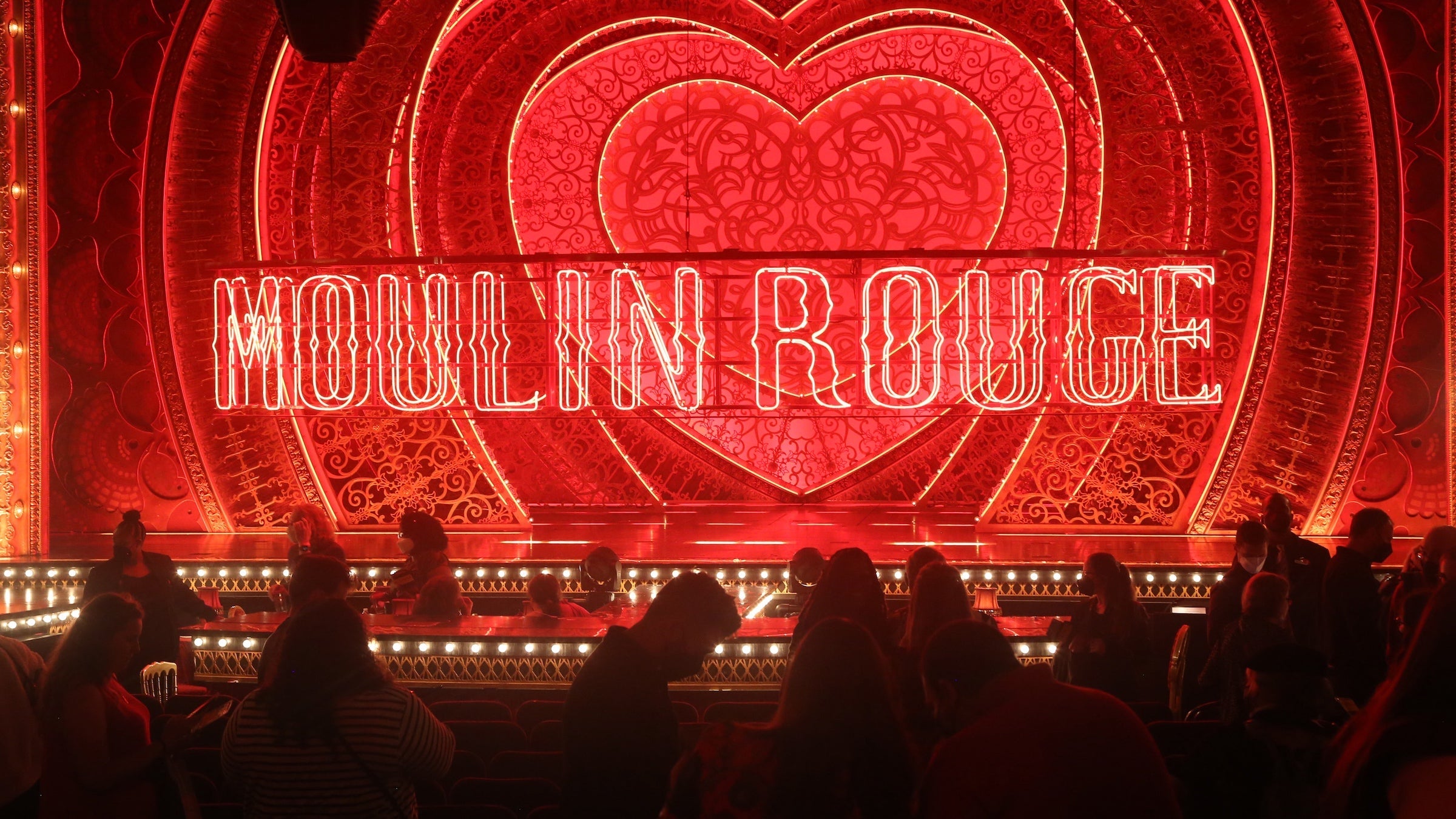 A dark red theater stage of Moulin Rouge