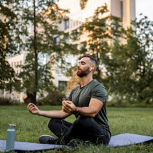 Man meditates outside
